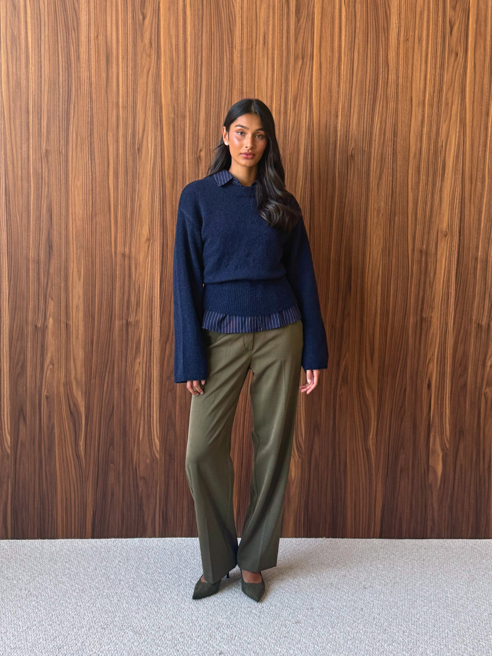 Indigo blue wool blend knitted sweater with olive green high-waisted suit trousers.